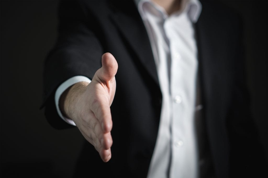 sales-coach-reaching-to-shake-hand